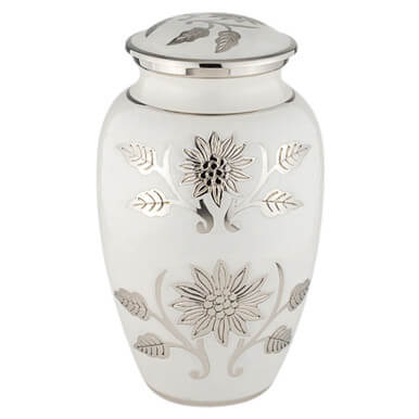 White urn with silver floral designs on a white background